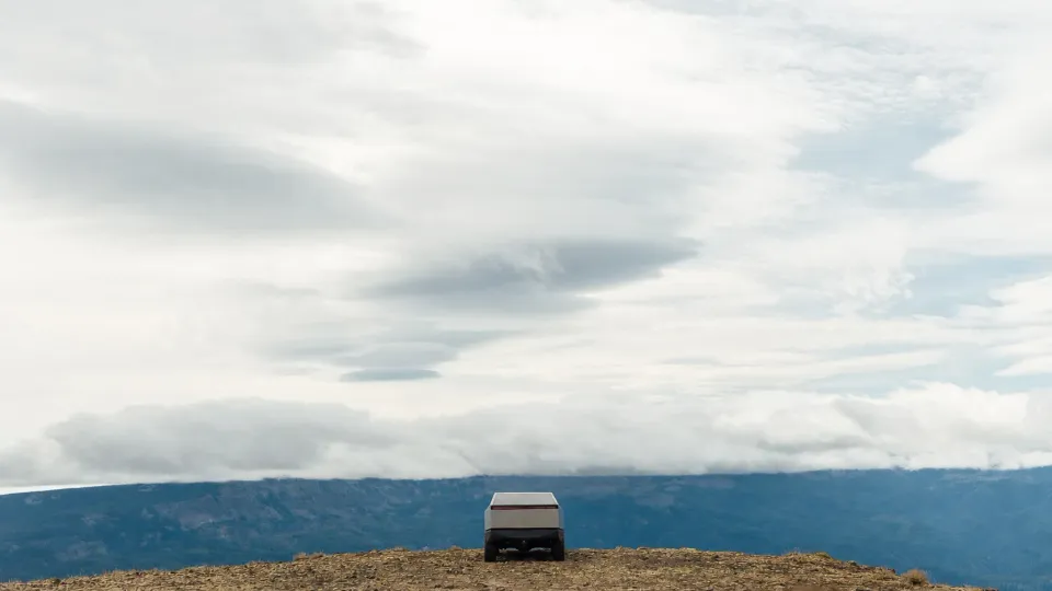 A Tesla Cybertruck below a large sky on Bethel Ridge in Washington