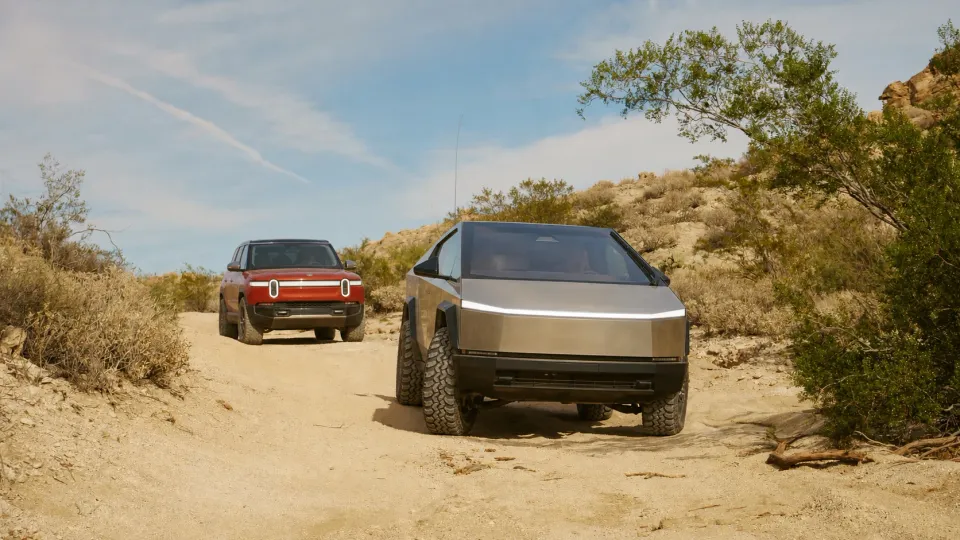 A Tesla Cybertruck and a Rivian R1T on Mojave Road in California