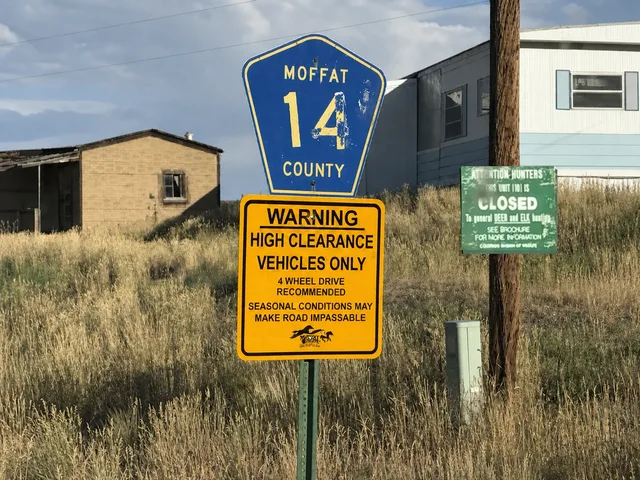 the County Road 14 and high-clearance warning signs on Yampa Bench Road in Dinosaur National Monument.