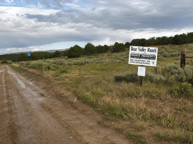 the road-closure and route signs at the fork on Yampa Bench Road in Dinosaur National Monument.