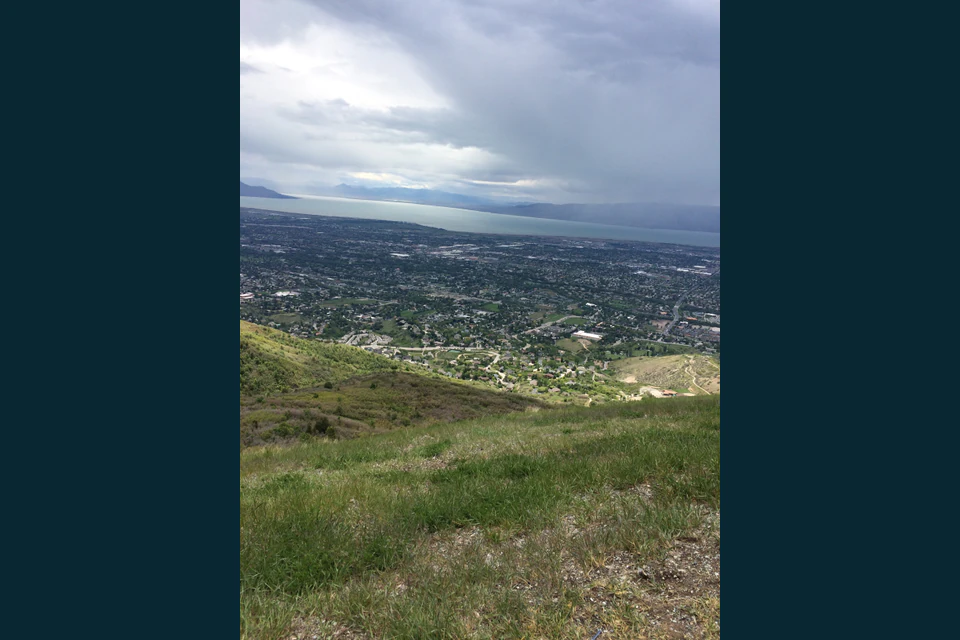 A broad valley view framed by steep Wasatch slopes in the Kyhv Peak area.
