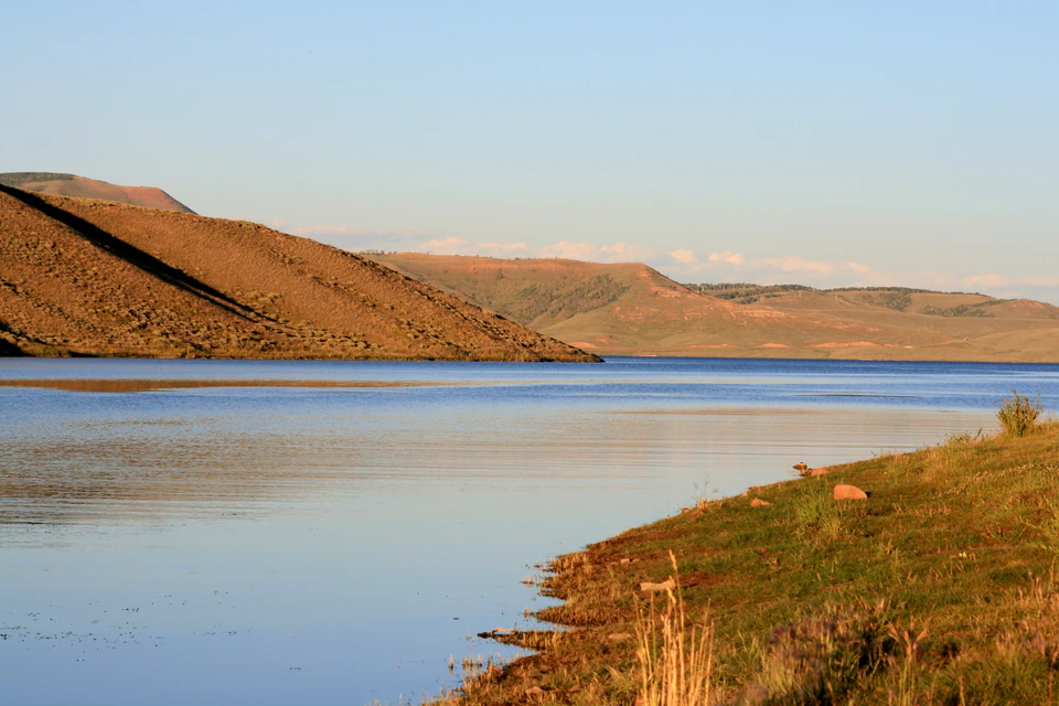 Warm sunset colors reflected across Strawberry Reservoir near Mud Creek.