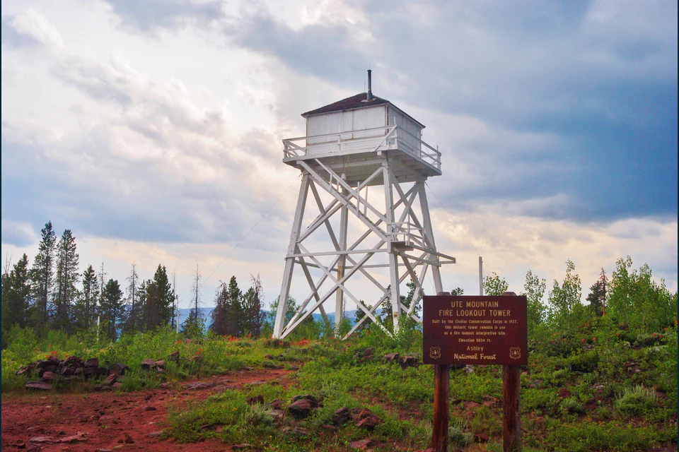 Ute Mountain fire lookout tower and Forest Service sign on the summit.